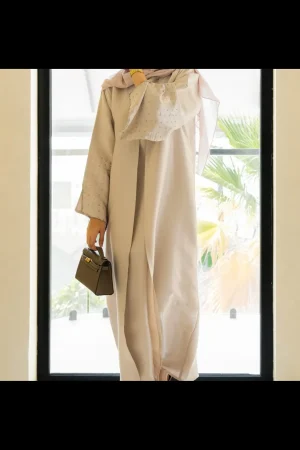 Model wearing a beige abaya