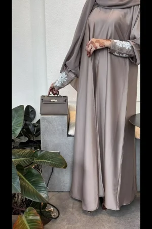 Model wearing a taupe open abaya
