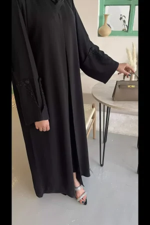 Black buttoned abaya worn by a model
