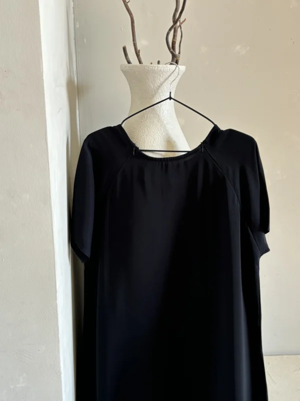 Chic black abaya designed for breastfeeding, offering subtle zip detailing and a refined look.
