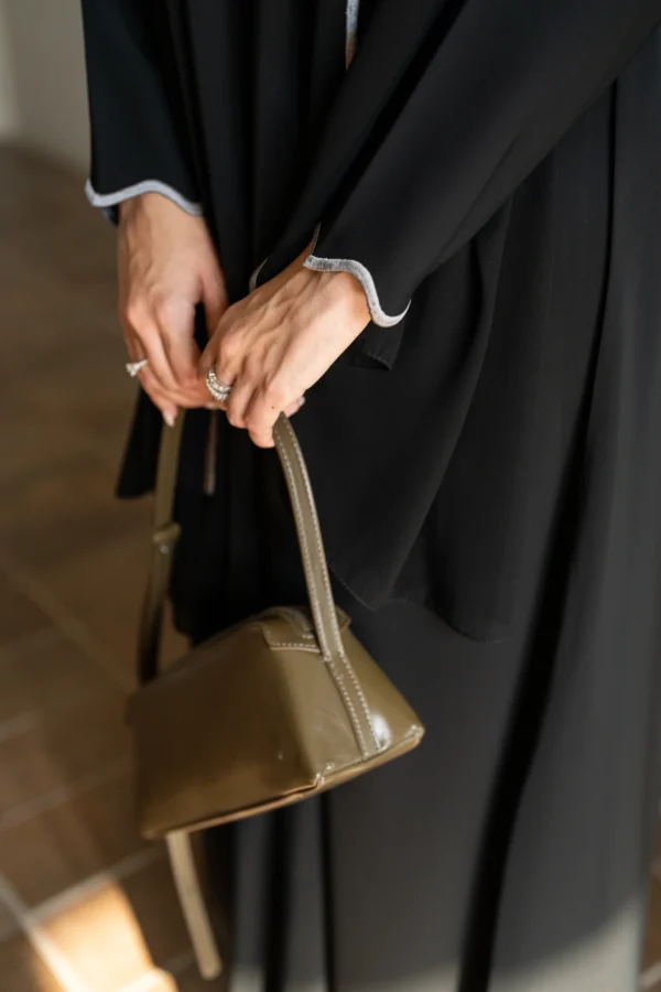A model wearing a black abaya
