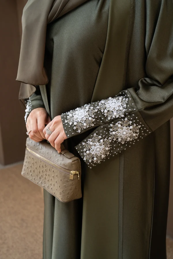 A model showing off olive abaya sleeve