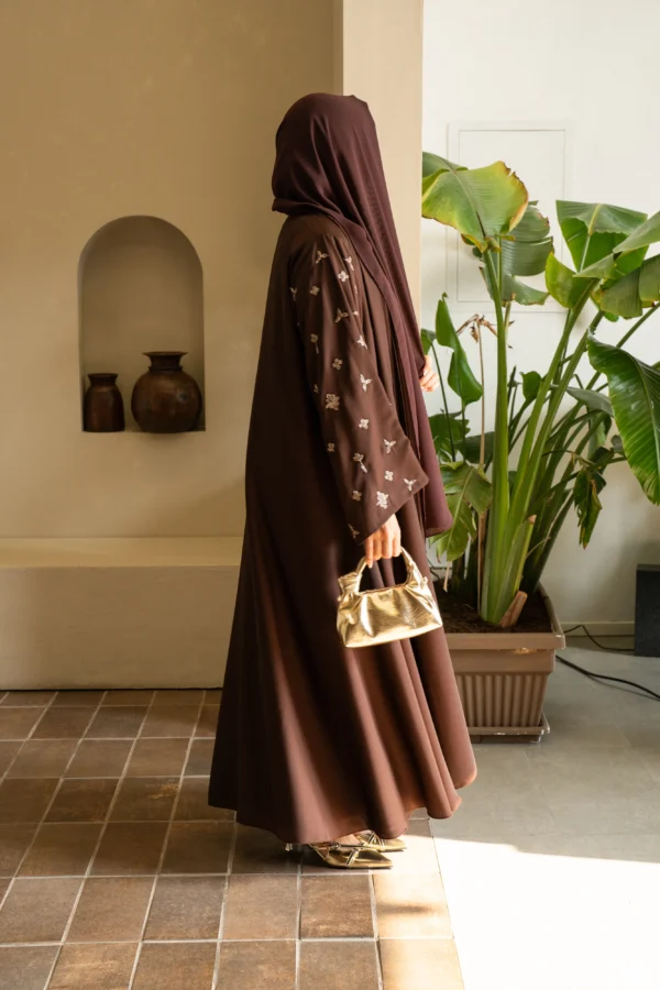 A model in a coffee shade abaya and matching scarf