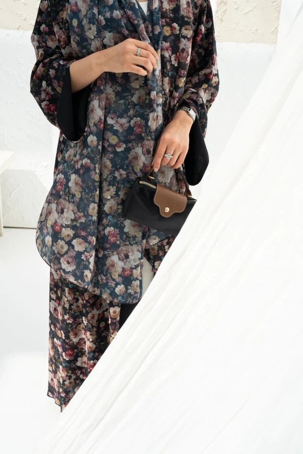 A model wearing a floral print dark abaya