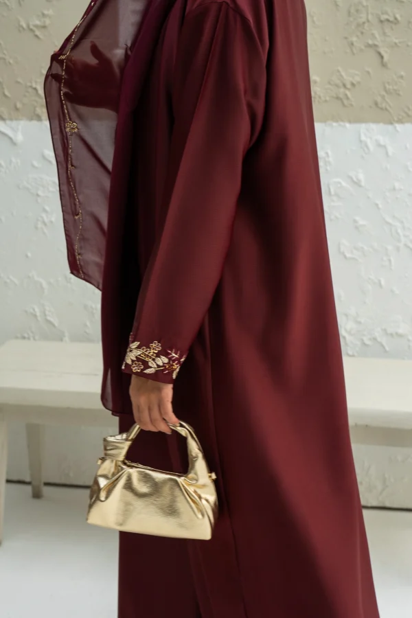 Maroon abaya dress worn by a model