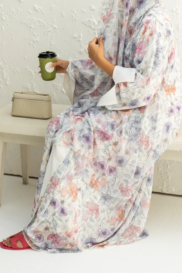 A model wearing a blue chiffon abaya with matching hijab
