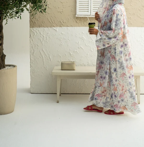 A model in a multi color chiffon abaya