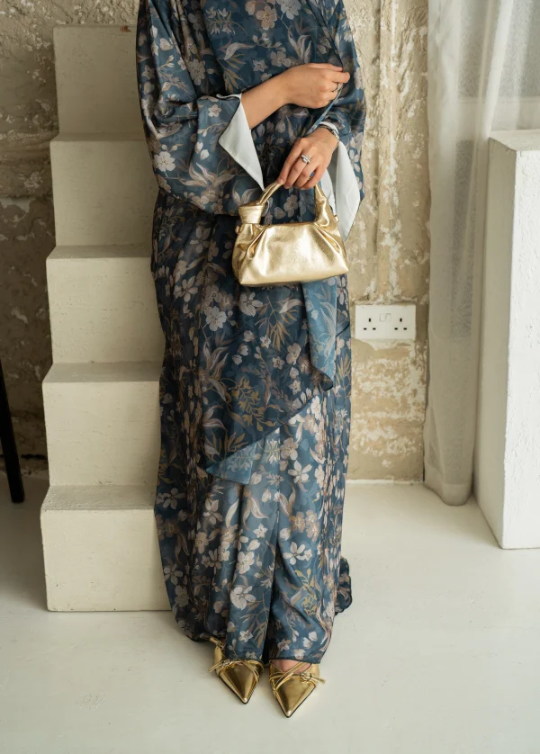 A model wearing mahra abaya teal floral