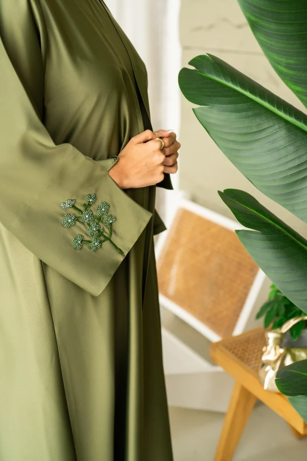 A model wearing an embellished green dress
