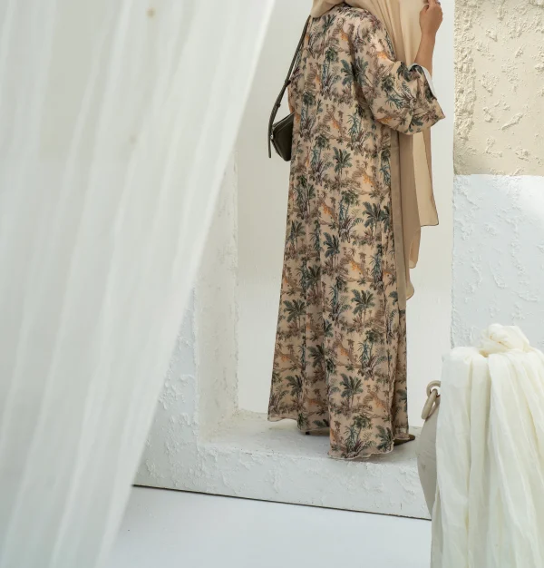 A model in a butter cream abaya with matching hijab
