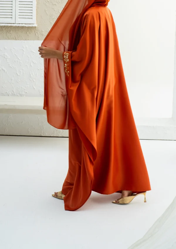 A burnt orange kaftan dress with matching hijab