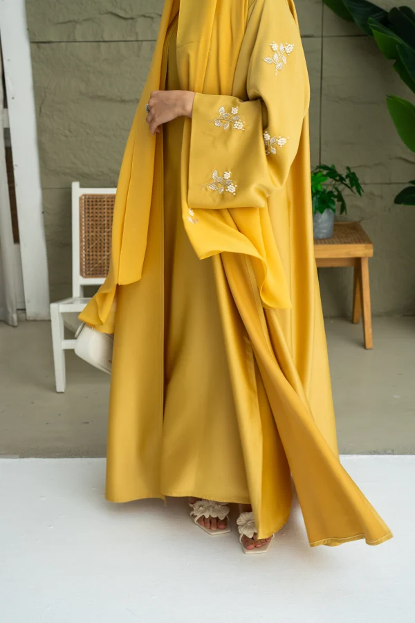 A model in a three piece abaya embroidery sleeve
