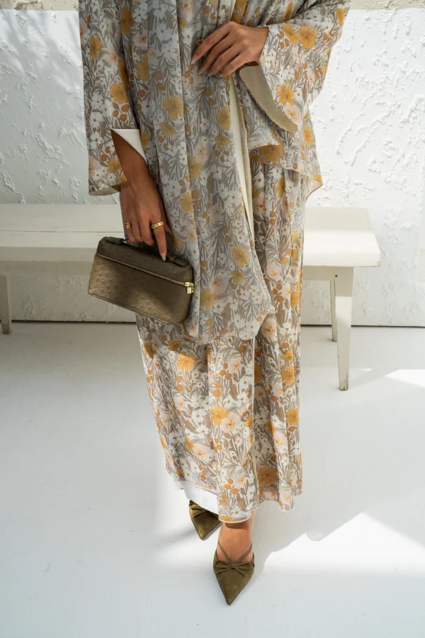 A model in a chiffon abaya dress with a matching scarf