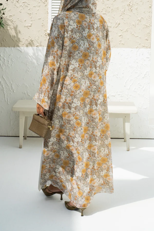 A model wearing a yellow chiffon abaya dress